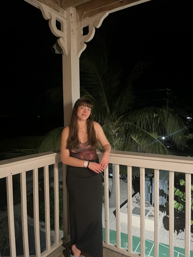 Person standing on a balcony for a photo.